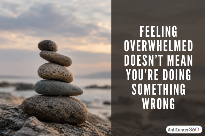 Feeling overwhelmed doesn’t mean you’re doing something wrong, displayed beside a stack of balanced stones.